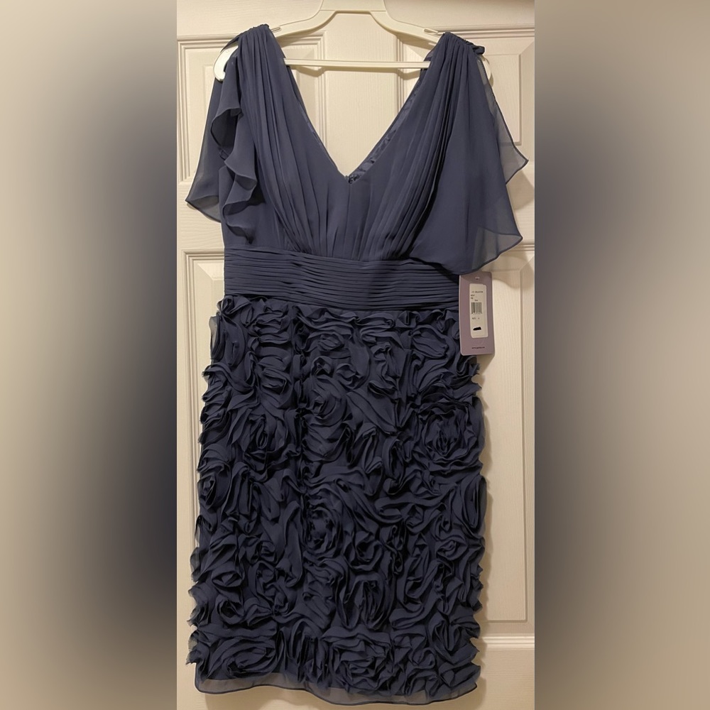 V-neck cocktail dress w/rosettes on bottom half. Fully lined w/back zipper. NWT